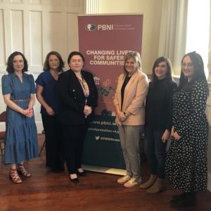 Photo of Professor Siobhan O'Neill , Mental Heath Champion with Gillian Montgomery, Director of Operations, Jill Grant Assistant Director and staff from North West Team