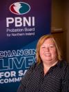 Photo of Pauline Somerville, Head of Information Technology in front of PBNI corporate popup