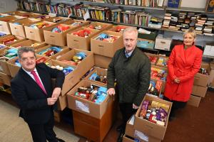 Photo of Amanda Stewart, Probation Chief Executive, and Prisons Director General, Ronnie Armour with  Robin Scott, Chief Executive of the Prison Fellowship NI, among the many gifts which have been donated by their staff to the Fellowship’s Christmas Hope Appeal which provides much-needed help for the families and children of those in prison.